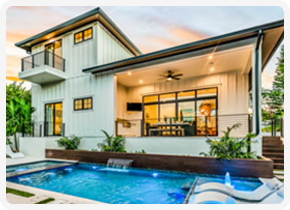 Modern coastal home with outdoor pool, covered patio, and sleek design accents.