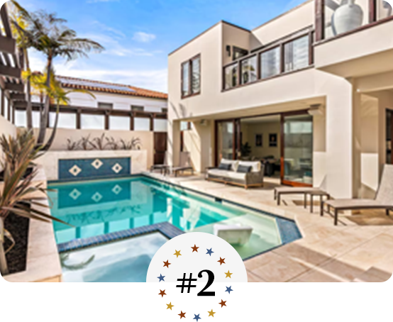 Contemporary home with private pool, sun loungers, and modern outdoor seating area.
