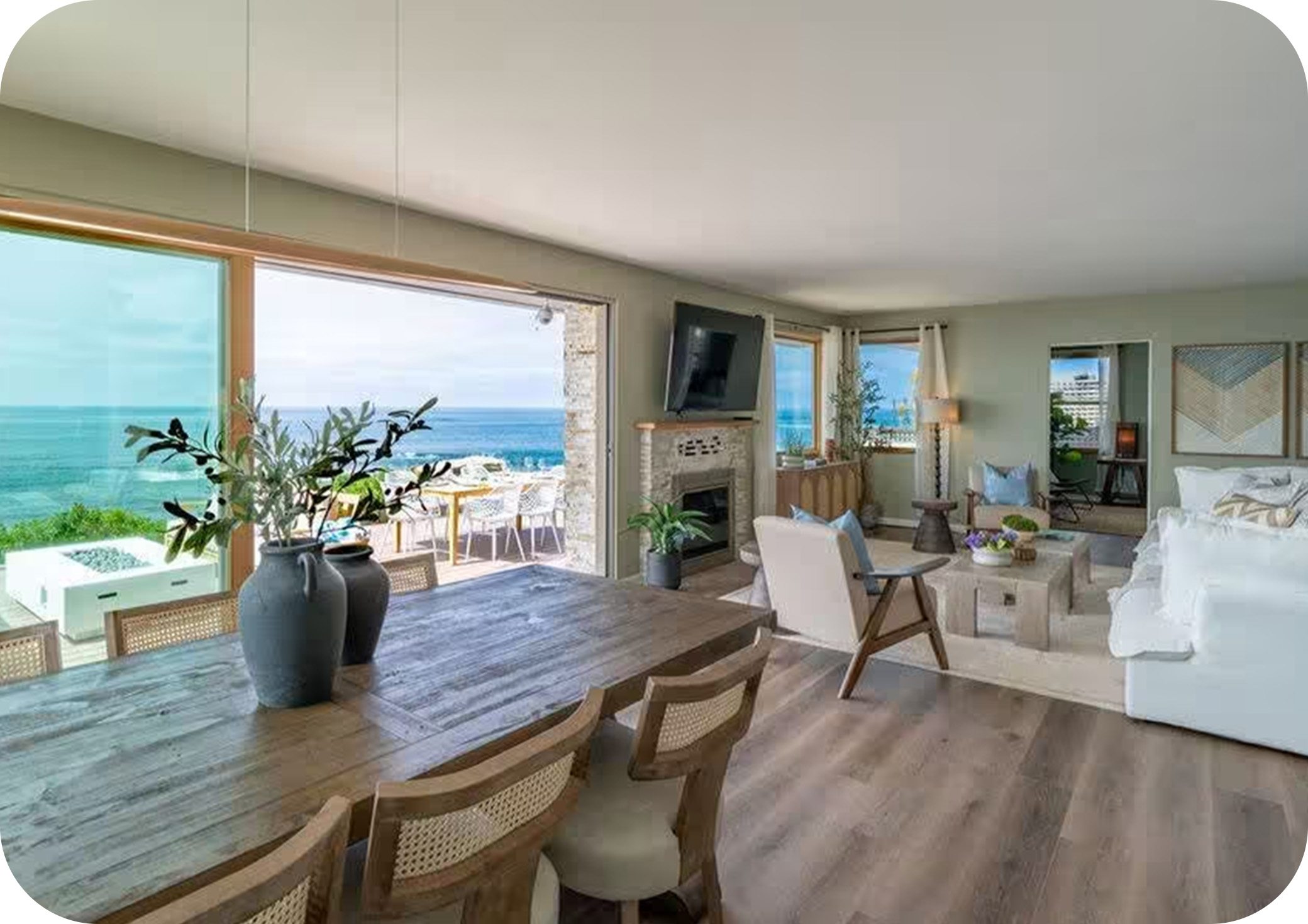 Open dining area with ocean views, wooden table, and coastal décor.