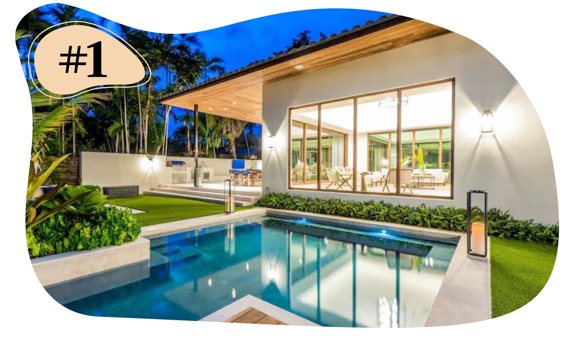 Home featuring a pool and lit patio at dusk, with indoor seating visible through large windows.