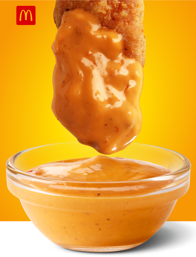 McCrispy Strip dipped in sauce.