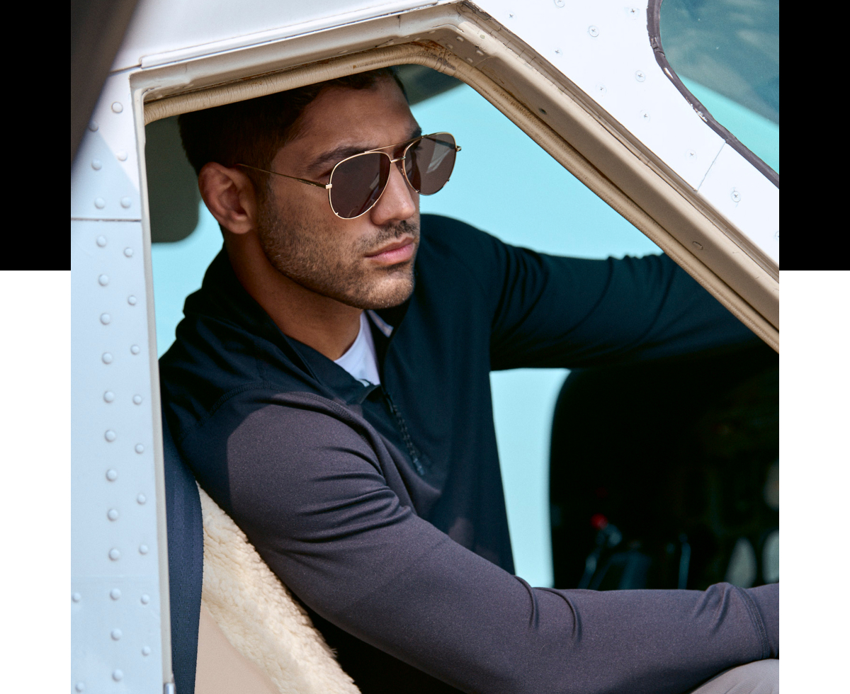 man wearing sunglasses and a dark long-sleeve polo