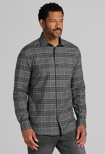 Man wearing a gray plaid long-sleeve shirt, standing against a light background.