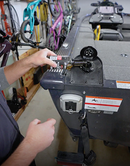 A man is working on a boat in a garage