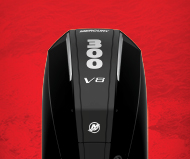 A black mercury outboard motor on a red background