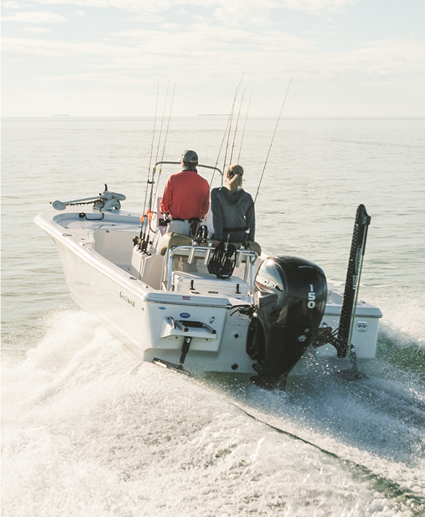 a couple on a boat with a Mercury outboard engine