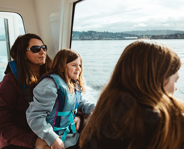 A girl wearing a life jacket with the word columbia on it