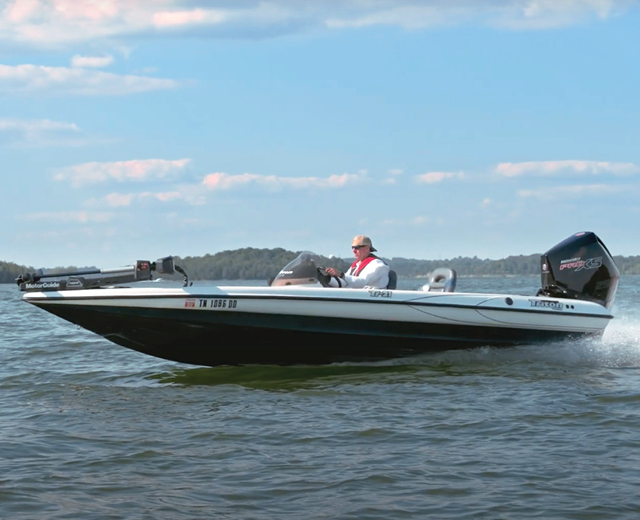 Man driving a Mercury repowered bass boat