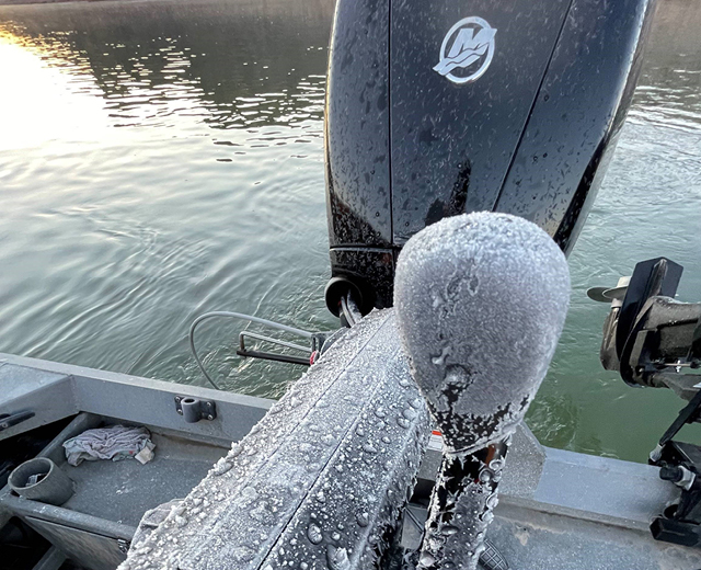 A mercury outboard motor is covered in frost