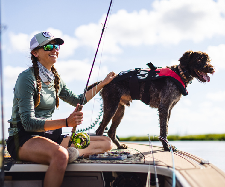A women with a mercury shirt enjoying boating on the water