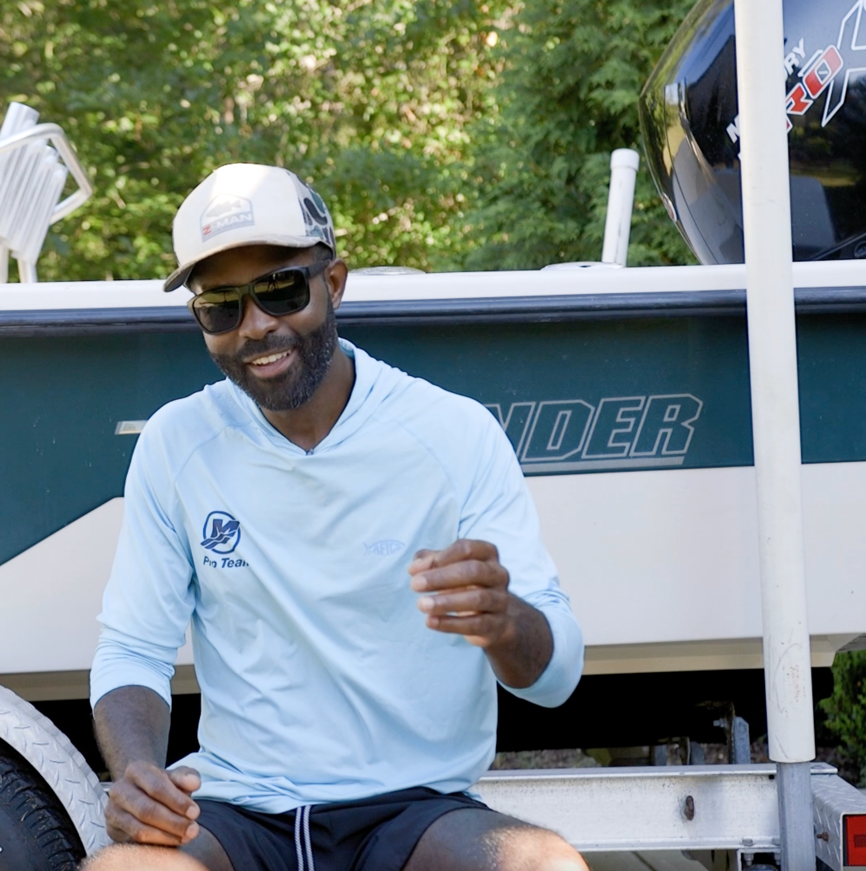 angler sitting next to a used boat with a Mercury engine