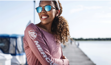 A woman smiles at the camera wearing a mauve long-sleeved Mercury shirt. Shop Women's.