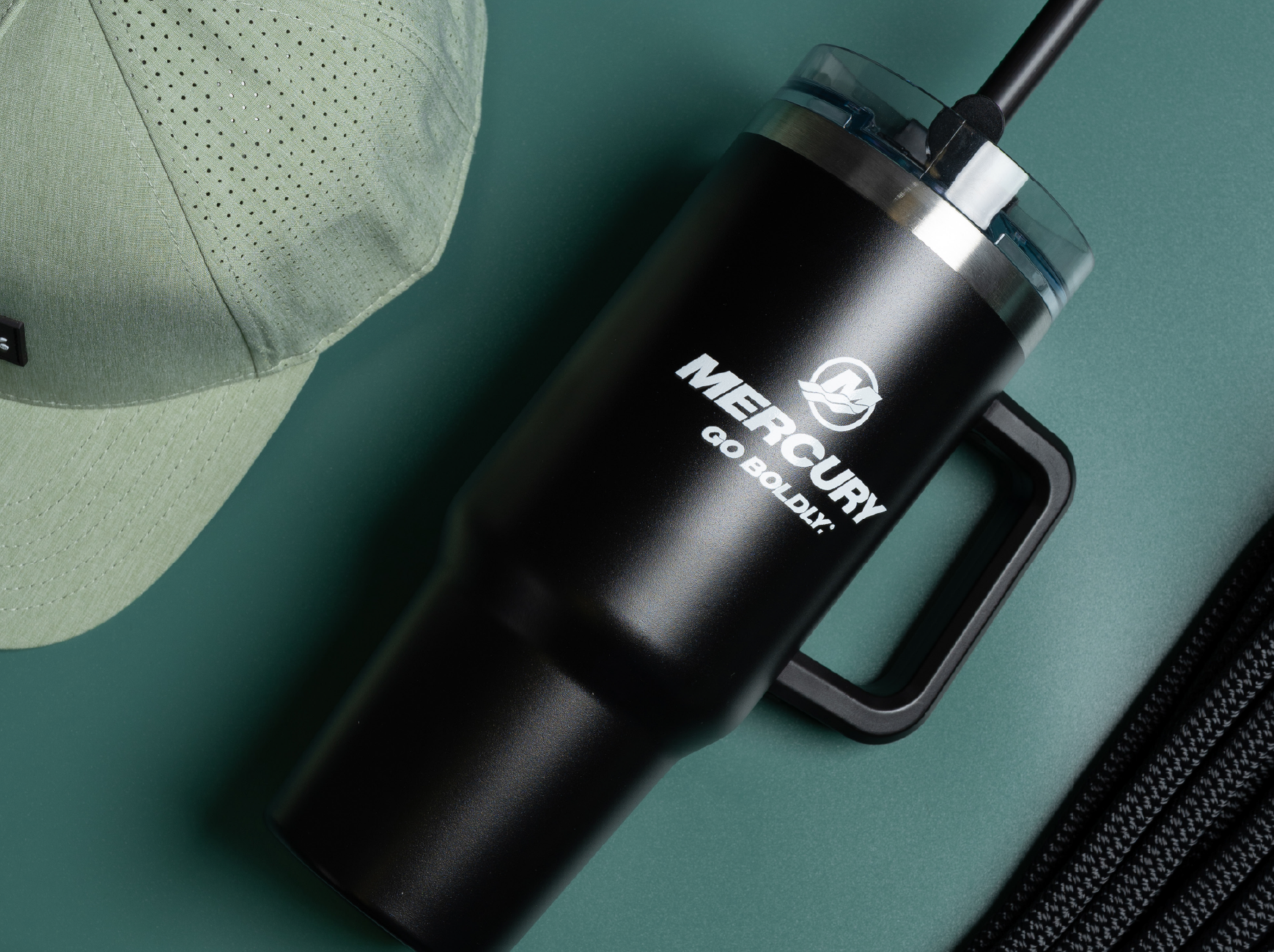 Find the perfect gift for Mother's Day! A Mercury-branded tumbler, baseball cap, and rope are displayed on a teal background.