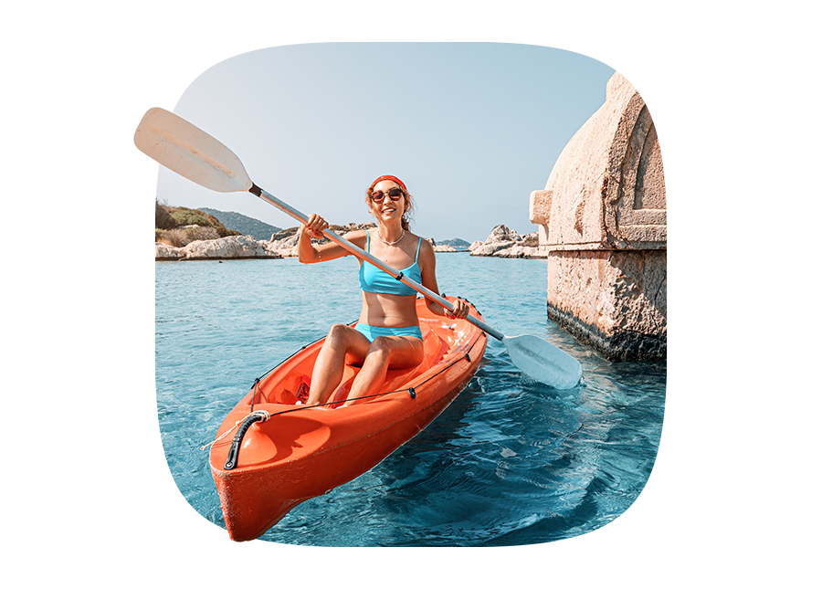 woman kayaking in an orange kayak