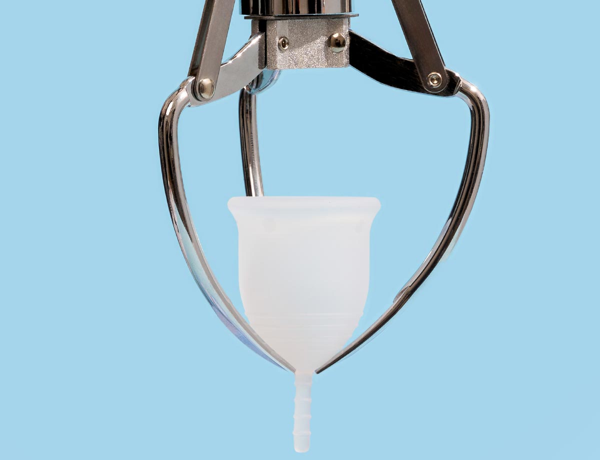 Menstrual Cup being held by claw machine claw