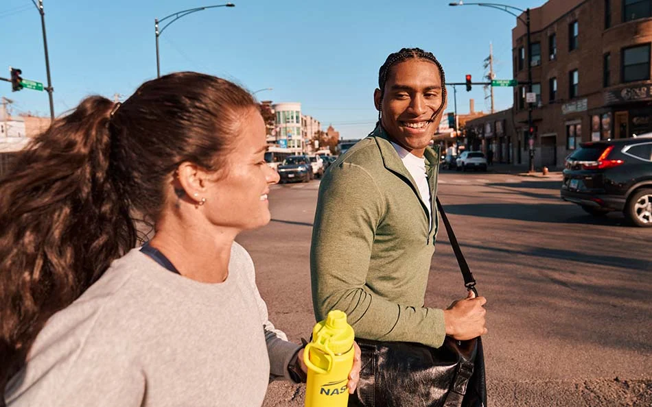 Two people walking and talking outdoors