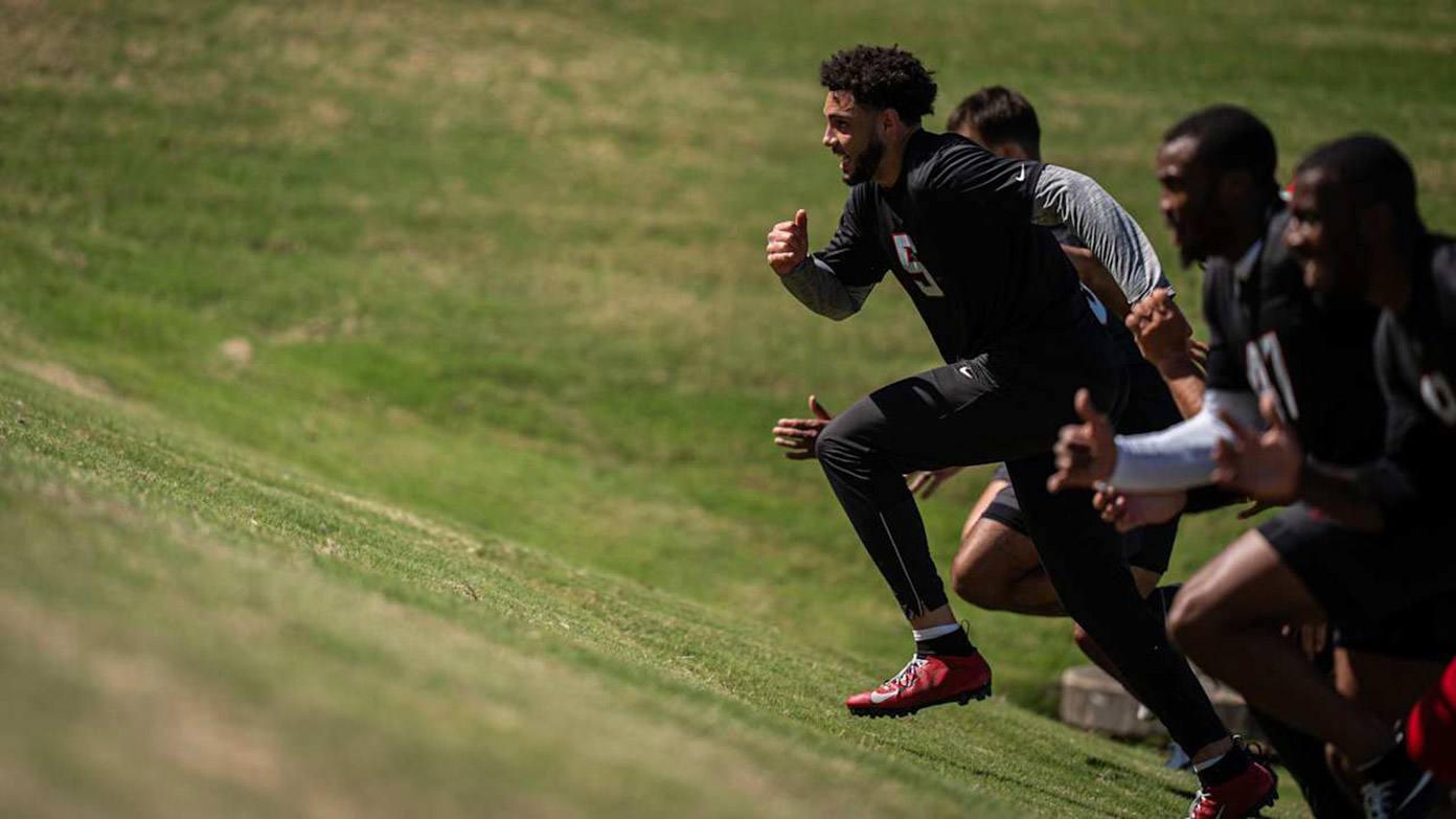 Falcons players complete uphill sprint drills during offseason training