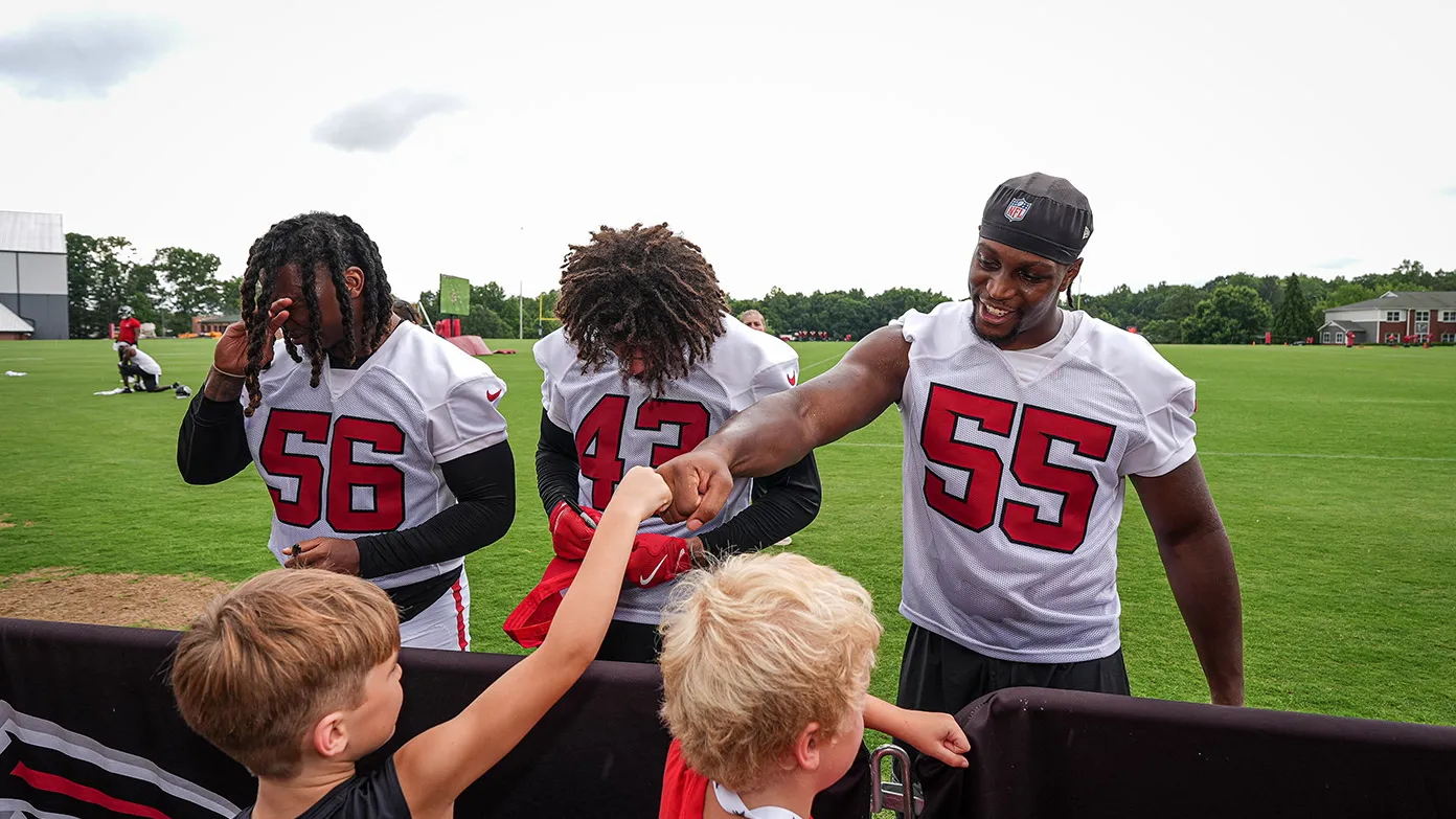 Harold Perkins Jr., Malik Verdon, and Channing Tindall greet youth