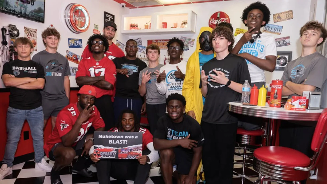 Atlanta Falcons rookies and high school football players after completing an escape room.