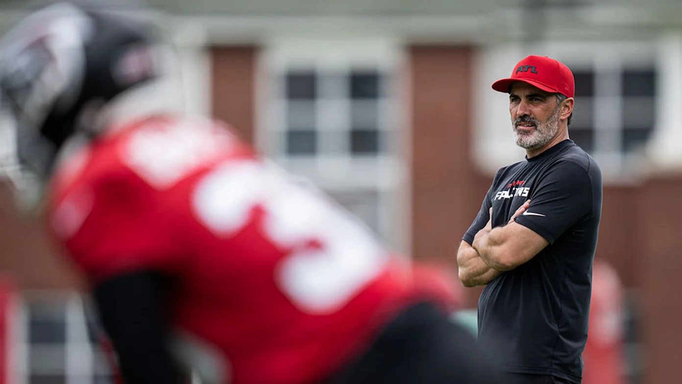 Falcons players practice near head coach Kevin Stefanski.