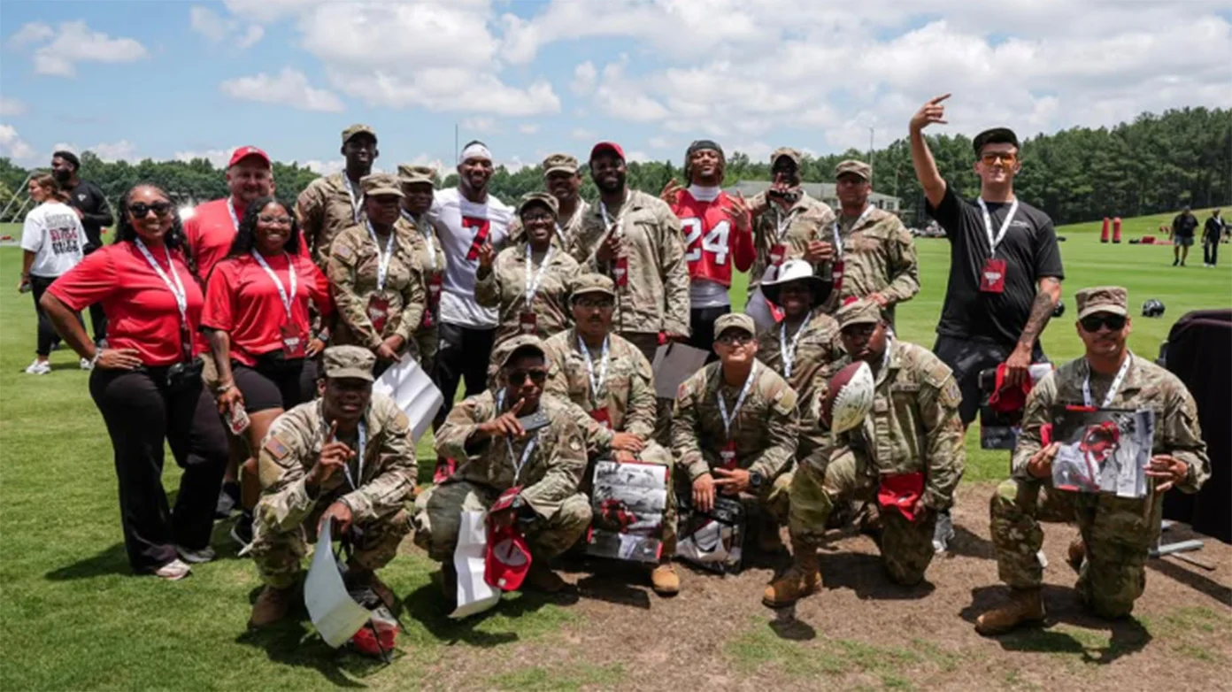Atlanta Falcons posing with military members from Fort Stewart