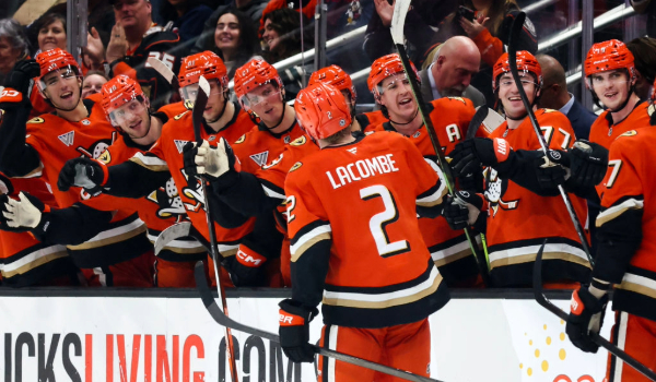Jackson LaCombe celebrates a goal with the bench at Honda Center