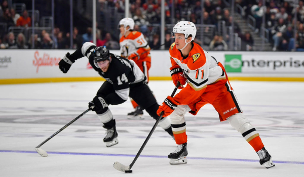 Trevor Zegras skating away from a Kiungs defender