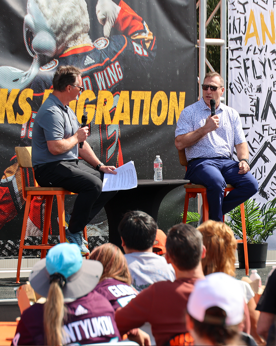 Photo of Anaheim Ducks General Manager Pat Verbeek speaking with Brian Hayward at the 2024 Ducks Migration event for Orange Alliance Members.