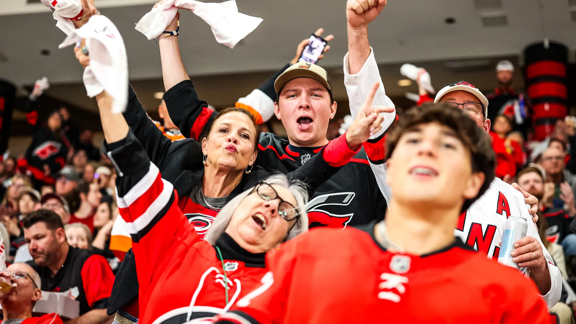 Caniacs cheering with rally towels during a playoff game at Lenovo Center