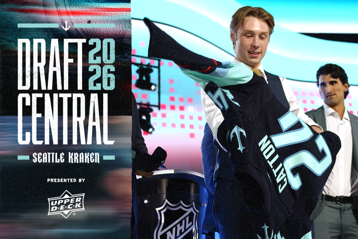 Berkly Catton putting on Kraken jersey after being drafted