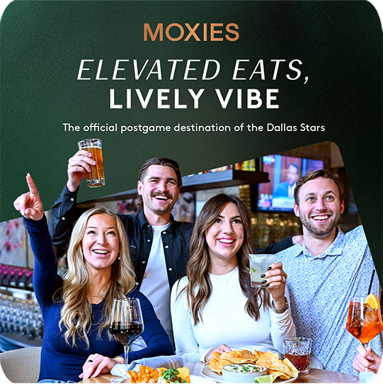 A group eating and drinking and cheering at Moxie's