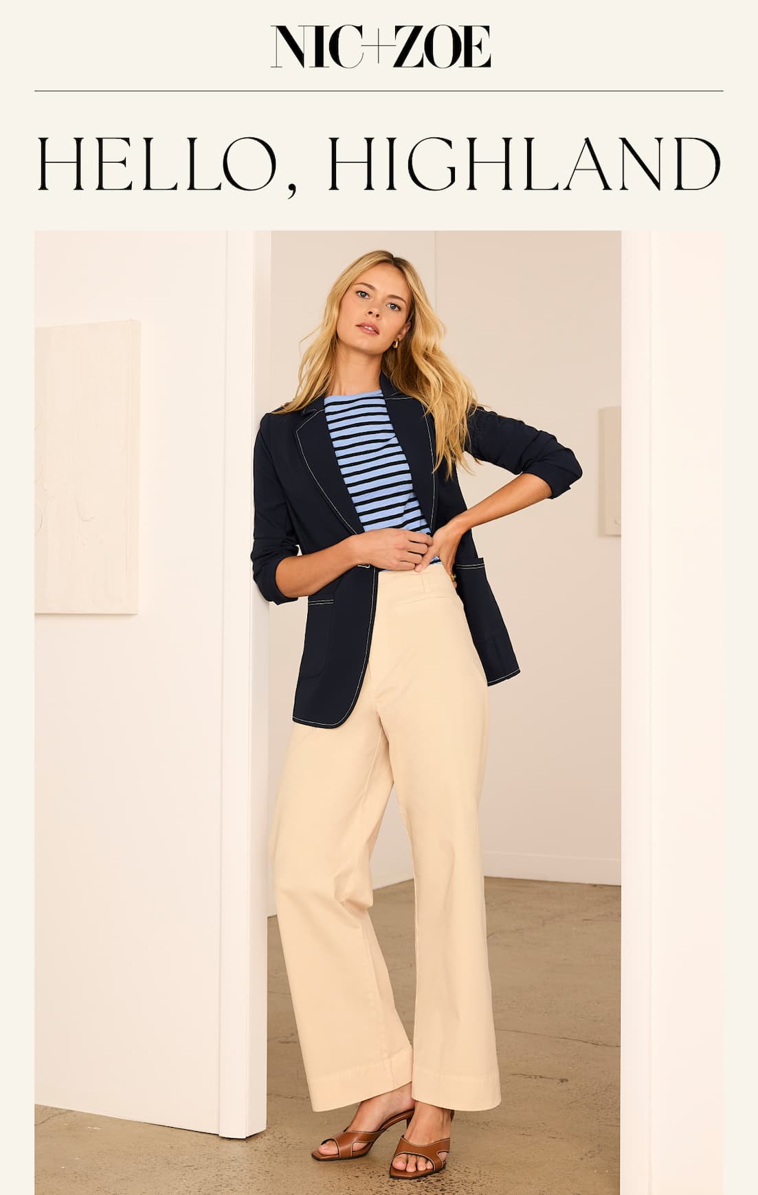Woman wearing the Highland Pant in Latte with a blue blazer and tee shirt.