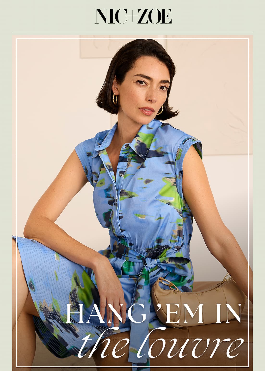 Lady wearing the water lilies camille dress is sitting beside the Hammitt Erica Small Handbag
