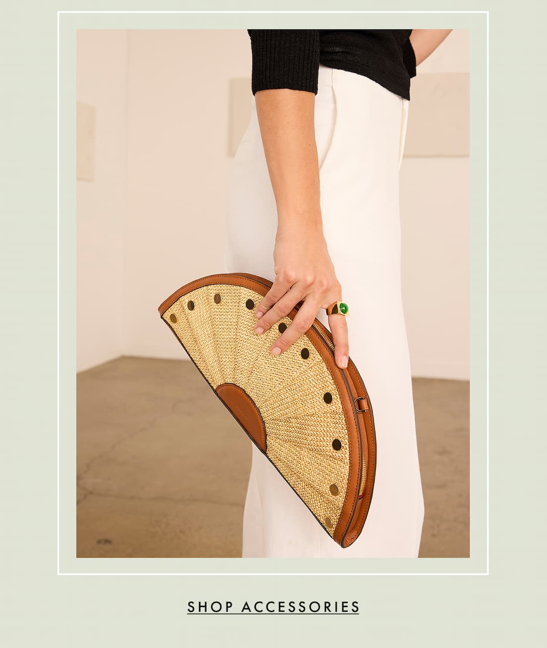 A lady holding the Hammitt Shelly Clutch. Shop accessories