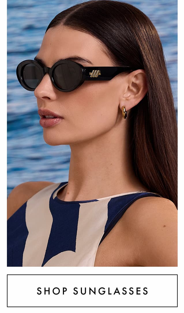 Shop sunglasses. The lady wearing the Le Specs Nouveau Black Oval Sunglasses.