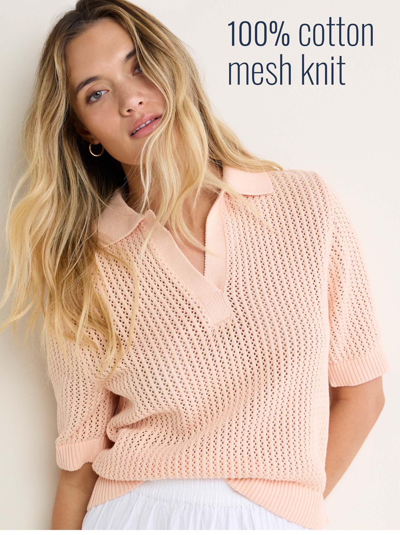 100% cotton mesh knit. The lady wearing the nz by NIC+ZOE Mesh Polo Sweater in Orange Sherbert.