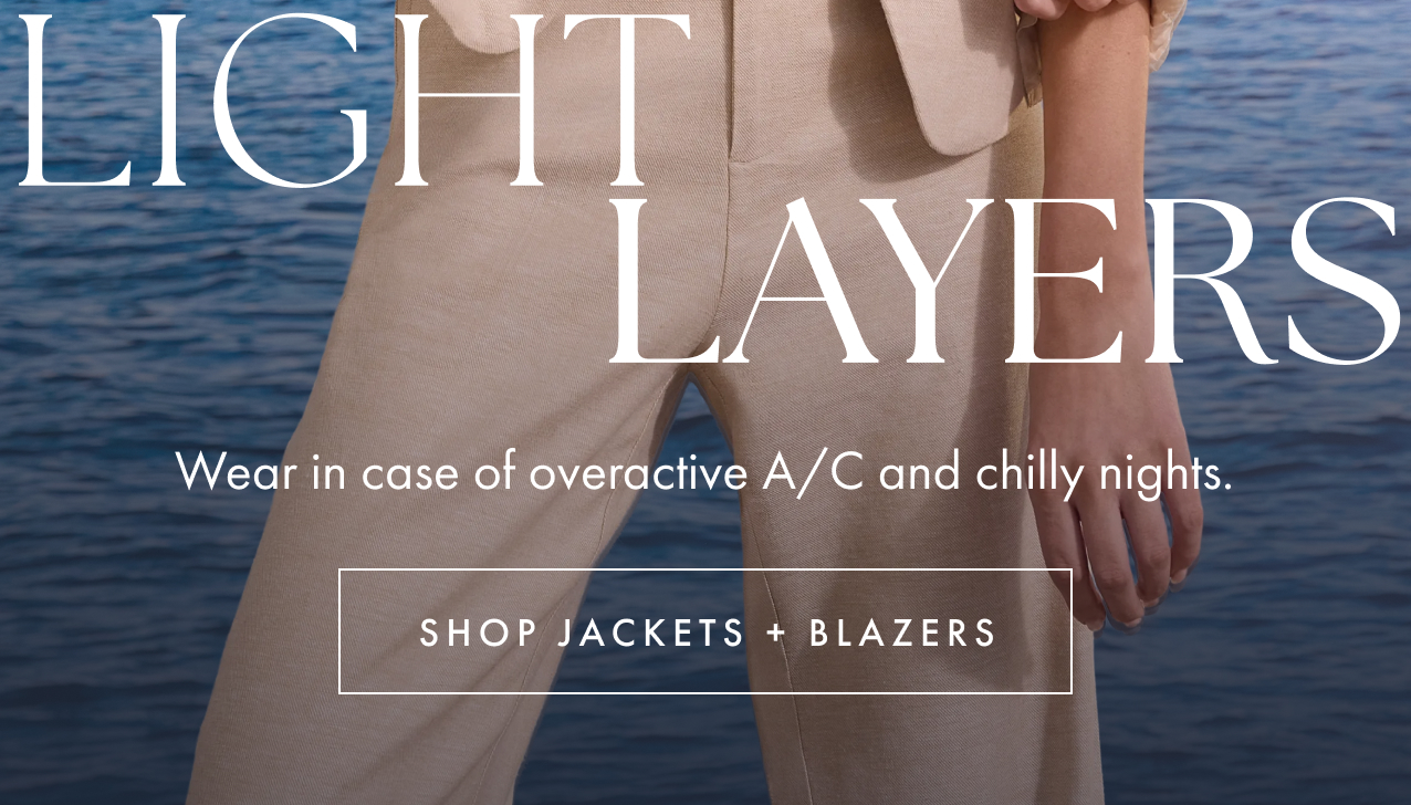 A woman posing in a cream-colored textured blazer layered over a button-up shirt and matching trousers, set against an ocean and blue sky background. Overlay text reads "LIGHT LAYERS." Wear in case of overactive A/C and chilly nights.