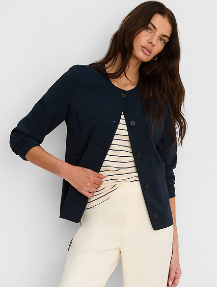 She wears the Collarless Sleek Stretch Jacket
