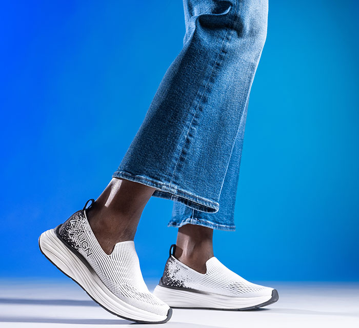 A person wearing the Align™ Thorne slip ons in white. Shop women's slip ons.