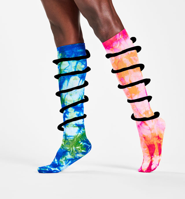 A woman wearing compression socks in multiple colors with spring doodles wrapping around the socks.