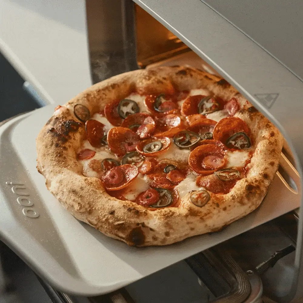 A gif of Ooni Volt 2 showing cooked salmon, cookies, pizza and bagels