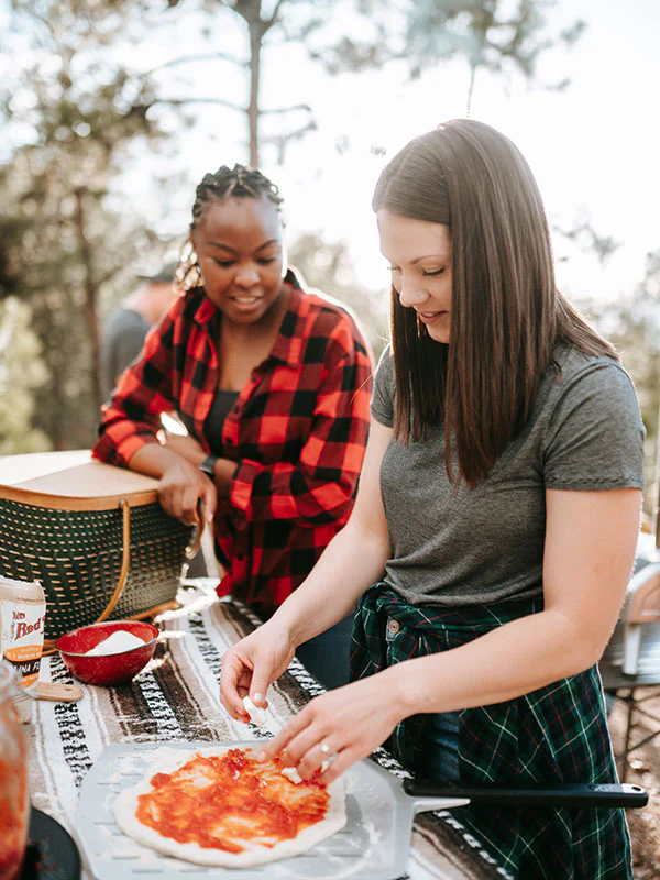 Built to last a lifestyle. Two women enjoying making pizzas.