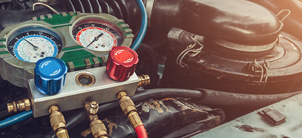 A vehicle's air conditioning system sitting atop the vehicle's engine