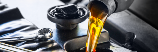 Pouring new motor oil into the reservoir
