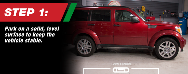 Step 1, Park on a solid, level surface to keep the vehicle stable.
