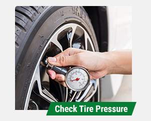 person checking tire pressure with gauge