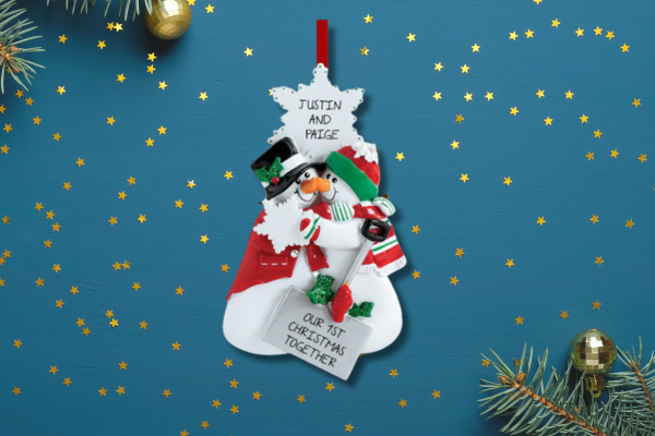 Couple ornament showing two people in cozy outfits with the label “Our First Christmas” and customizable names underneath.