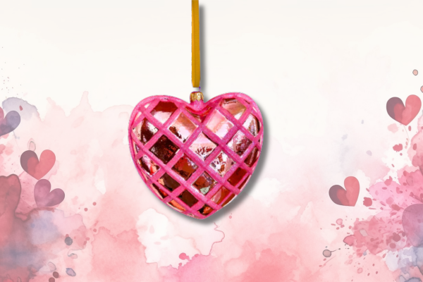 Pink and red glass heart ornament with a crisscross lattice design and gold ribbon—perfect for Valentine’s Day or celebrating love and affection.