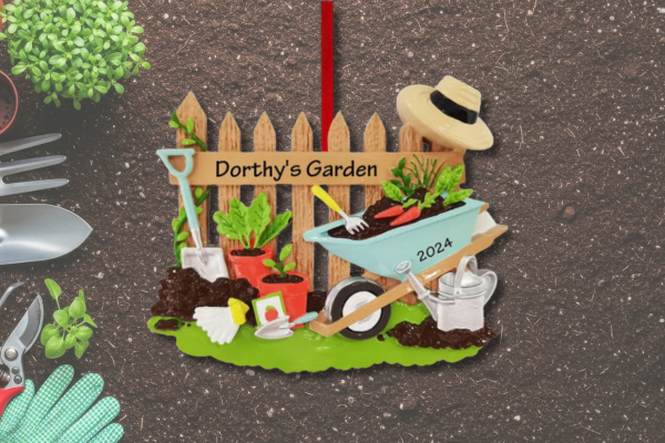 Personalized garden ornament featuring fence, wheelbarrow, plants, and custom name and year.