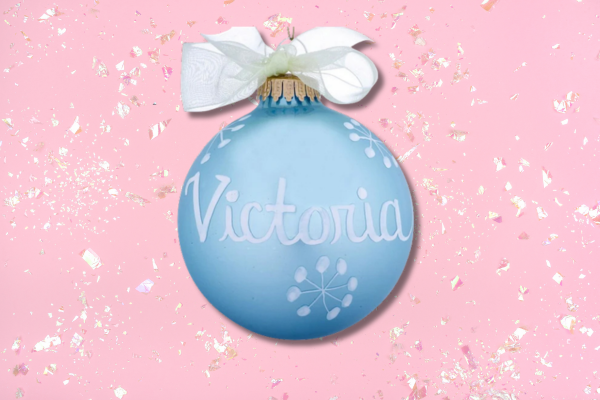 Blue glass ornament personalized with name, representing March aquamarine birthstone.